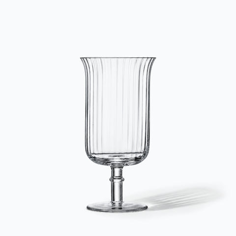 Verre long drink à pied Arpeggio seul sur fond blanc, corps cannelé et tige annelée, ombre portée